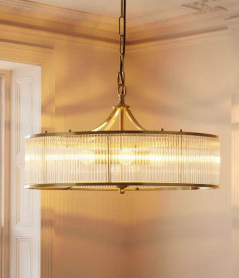 Pooky Athena Chandelier pendant light with elegant brass and glass rods creating a modern, sophisticated glow