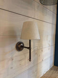Finberry Fabric Shade Lupin wall light with beige waffle fabric shade and bronze finish mounted on wooden wall