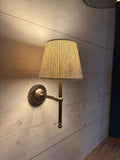 Finberry Fabric Shade Lupin wall light with beige waffle fabric shade and bronze finish mounted on wooden wall