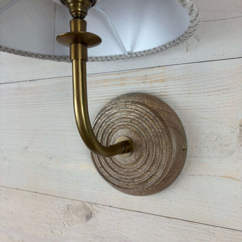 mangowood wall light fitting, with handcarved texture and a brass arm b22 fitting