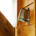 Bourne Outdoor Mast Light in brushed nickel finish mounted on wooden exterior wall