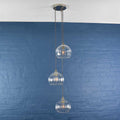 Soho medium ribbed glass 3 cluster pendant light with clear ribbed glass globes against blue brick wall
